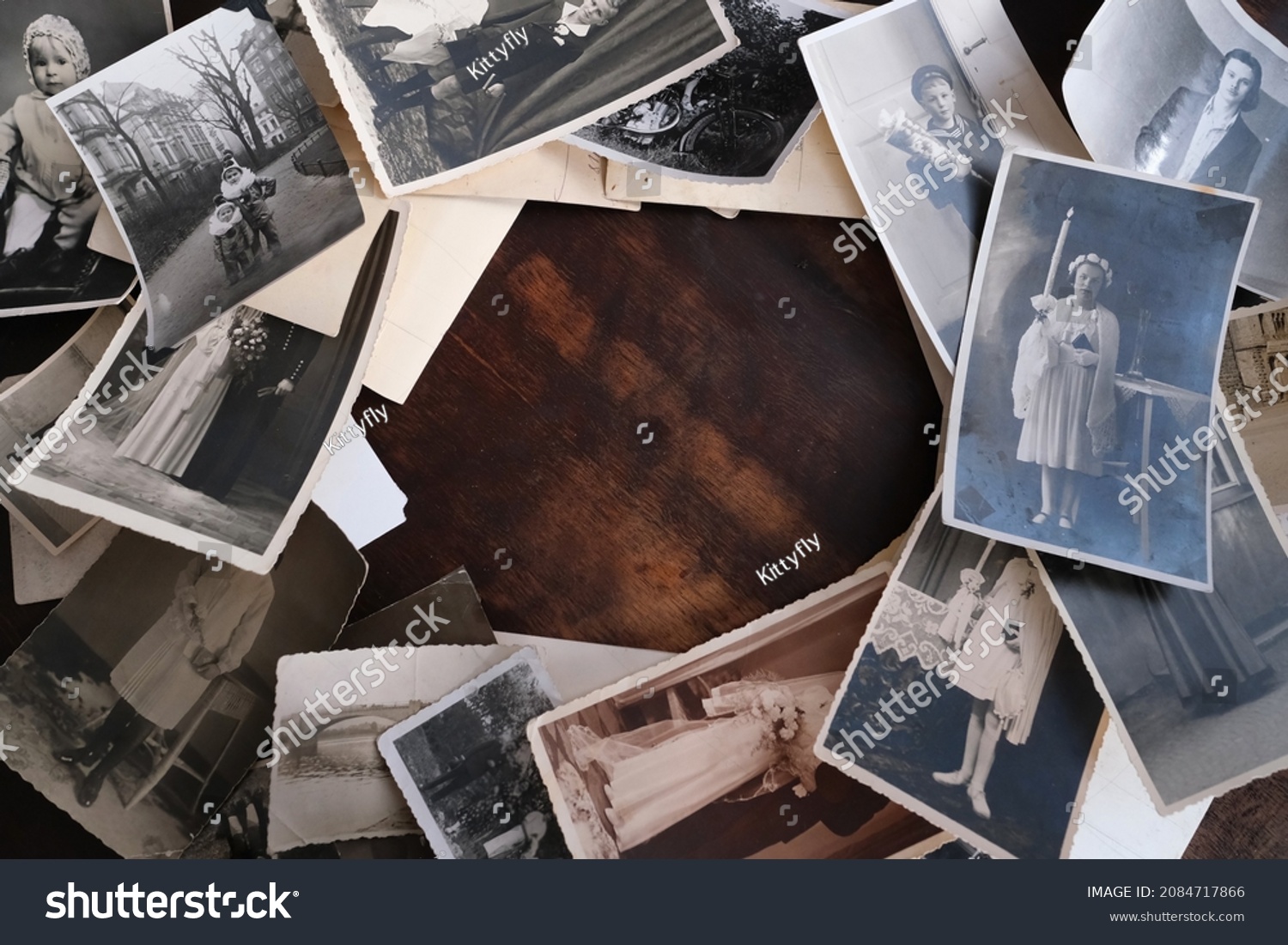 on an old wooden table there are old photographs of 1950-1960, , concept of family tree, genealogy, childhood memories, connection with ancestors #2084717866