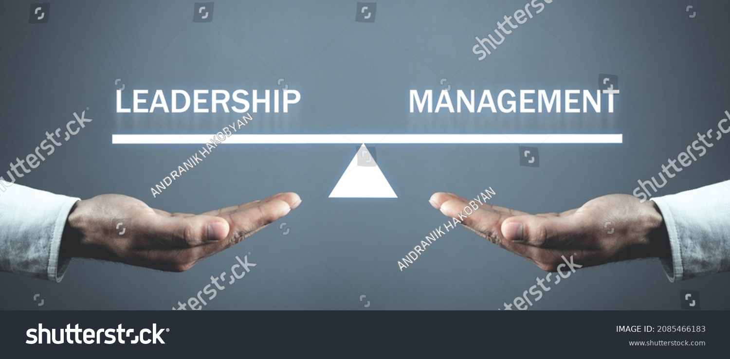 Male hands holding Leadership and Management balance scale. #2085466183