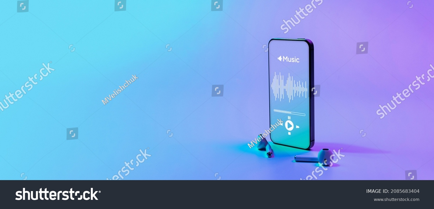 Music banner. Mobile smartphone screen with music application, sound headphones. Audio voice with radio beats on neon gradient background. Broadcast media music banner with copy space #2085683404