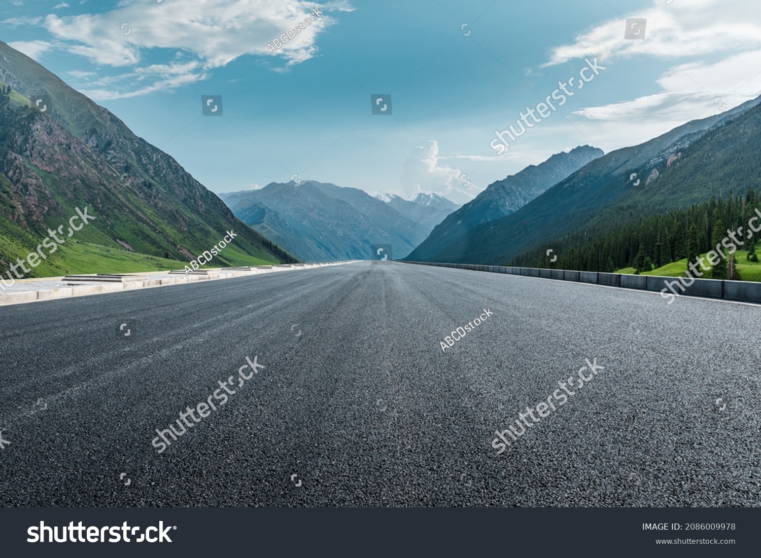 Straight asphalt road and mountain under blue sky. Highway and mountain background. #2086009978
