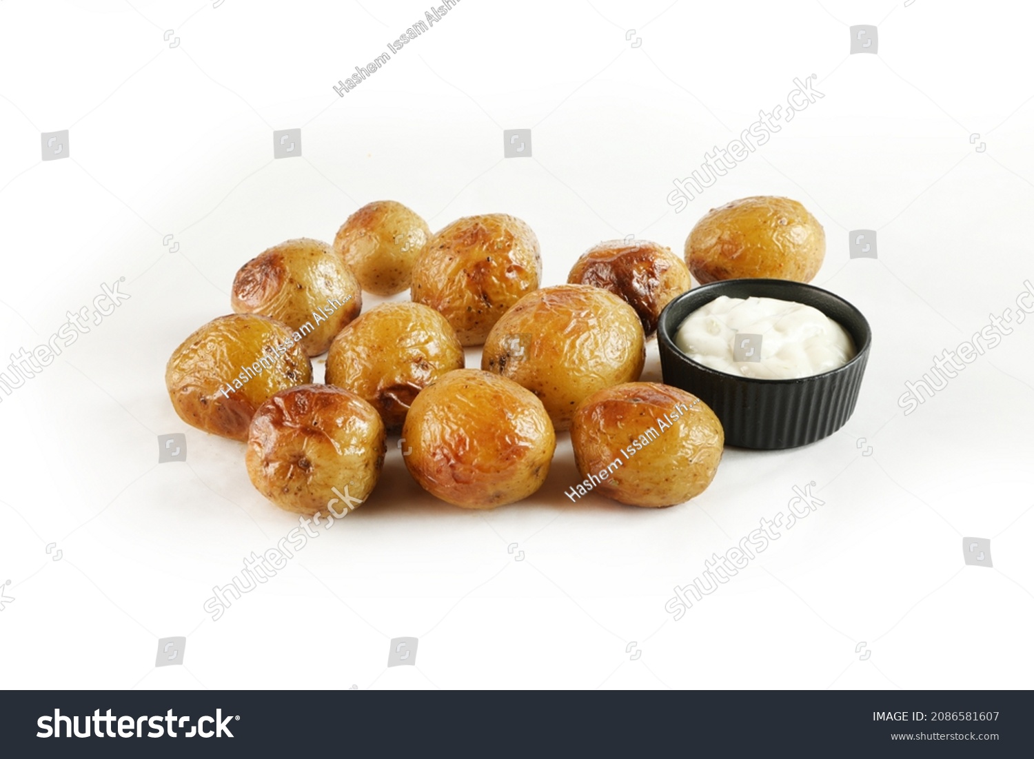 Young small potatoes baked with garlic, thyme and sea salt on white background 
 #2086581607