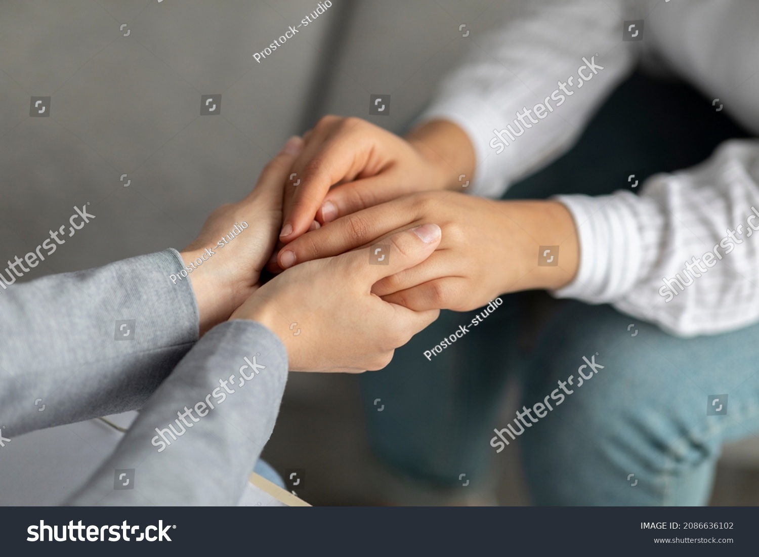 Psychological support. Psychotherapist offering help to young woman, holding her hands during psychotherapy session, closeup. Unrecognizable psychiatrist providing assistance to female patient #2086636102