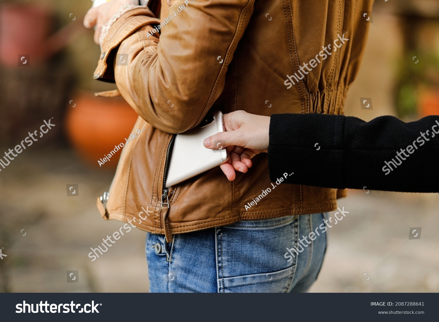 Pickpocket thief is stealing smartphone outdoors #2087288641
