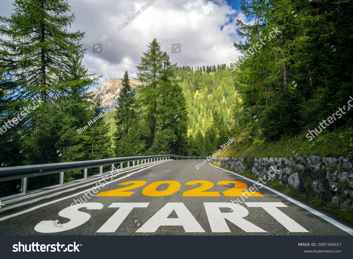 2022 New Year road trip travel and future vision concept . Nature landscape with highway road leading forward to happy new year celebration in the beginning of 2022 for fresh and successful start . #2087366017