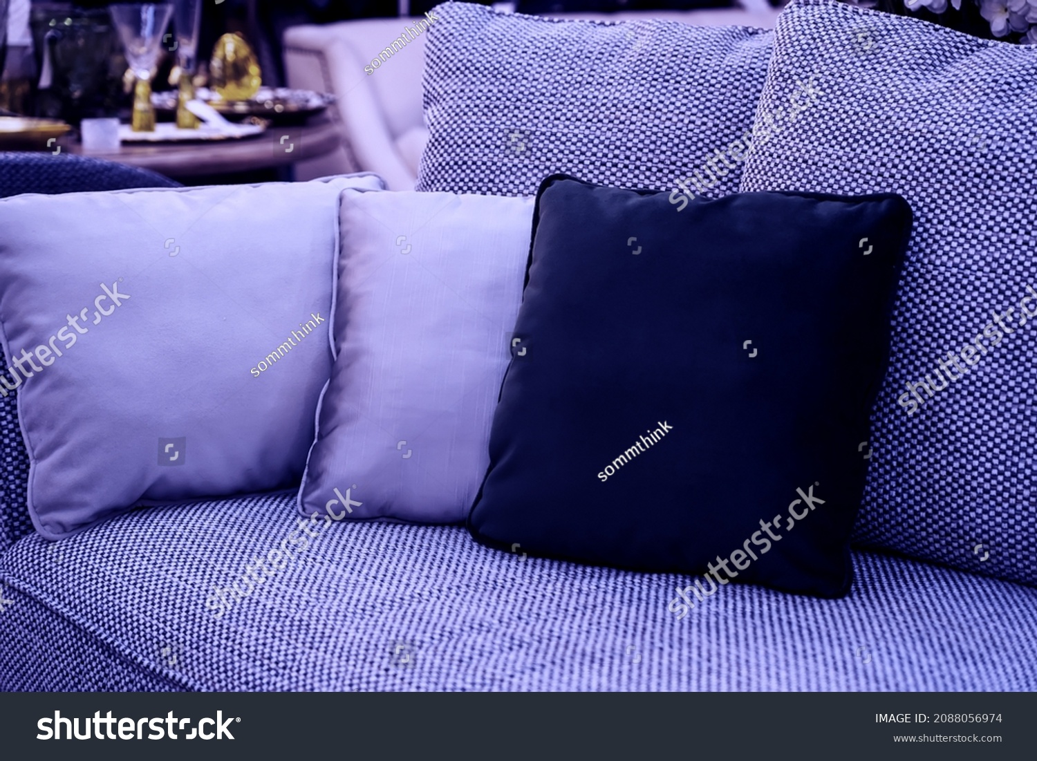 image toned in pantone color of the year 2022 very peri. cushions on cozy violet sofa. Pillows on casual couch in the living room #2088056974
