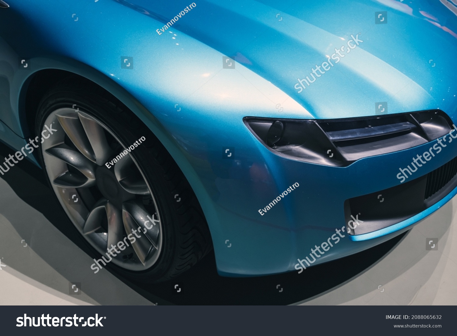 Headlight and wheel of a luxury blue roadster, conceptual sports car design elements #2088065632