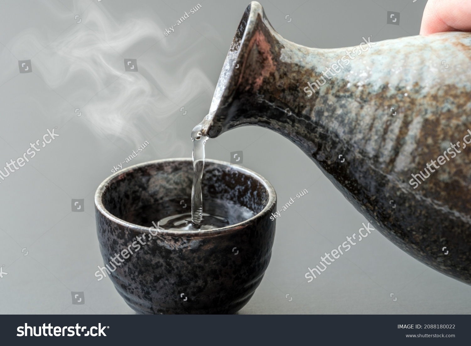 An image of pouring Japanese "liquor" into a bowl. #2088180022