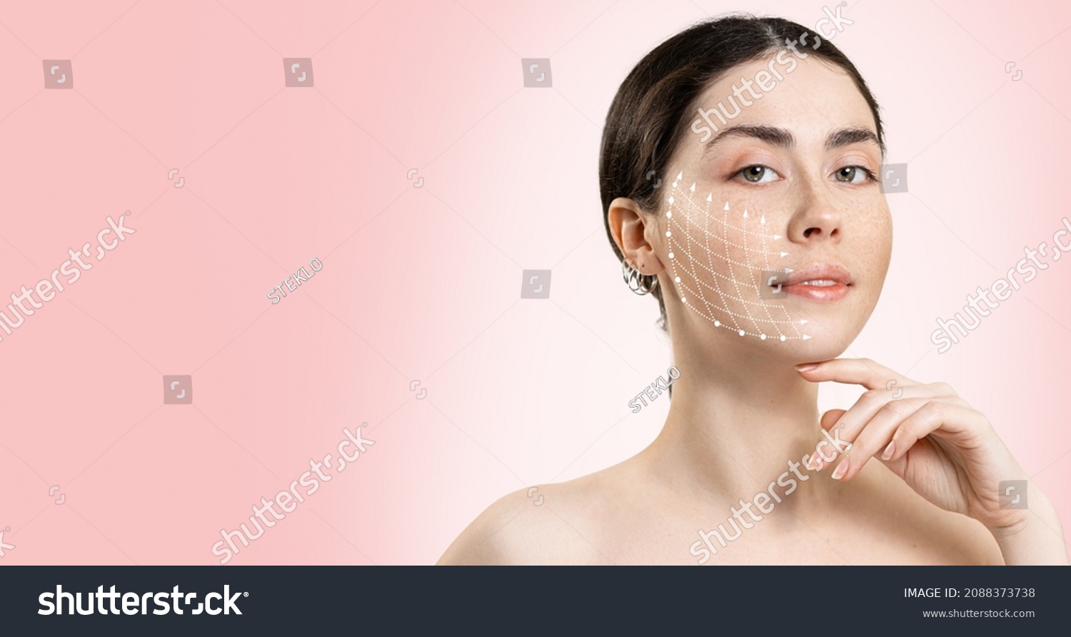 Banner of professional cosmetology. Portrait of a young beautiful woman with a mesh of thread lifting on her face. Pink background. Copy space. #2088373738