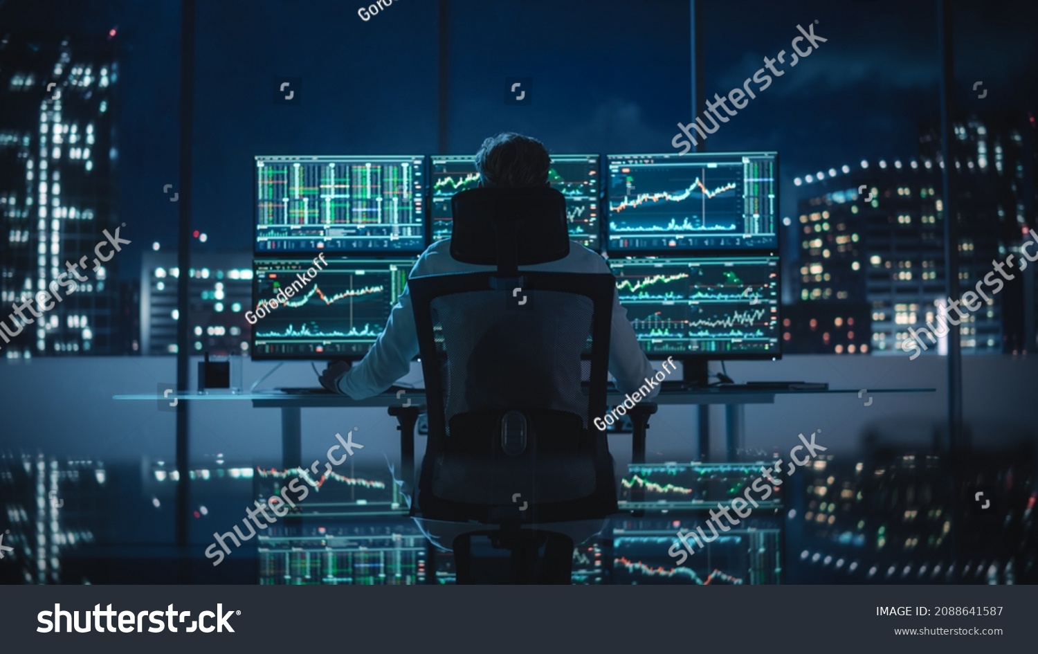 Financial Analyst Working on Computer with Multi-Monitor Workstation with Real-Time Stocks, Commodities and Exchange Market Charts. Businessman Deliberating on Next Investment Trade in a Bank Office. #2088641587