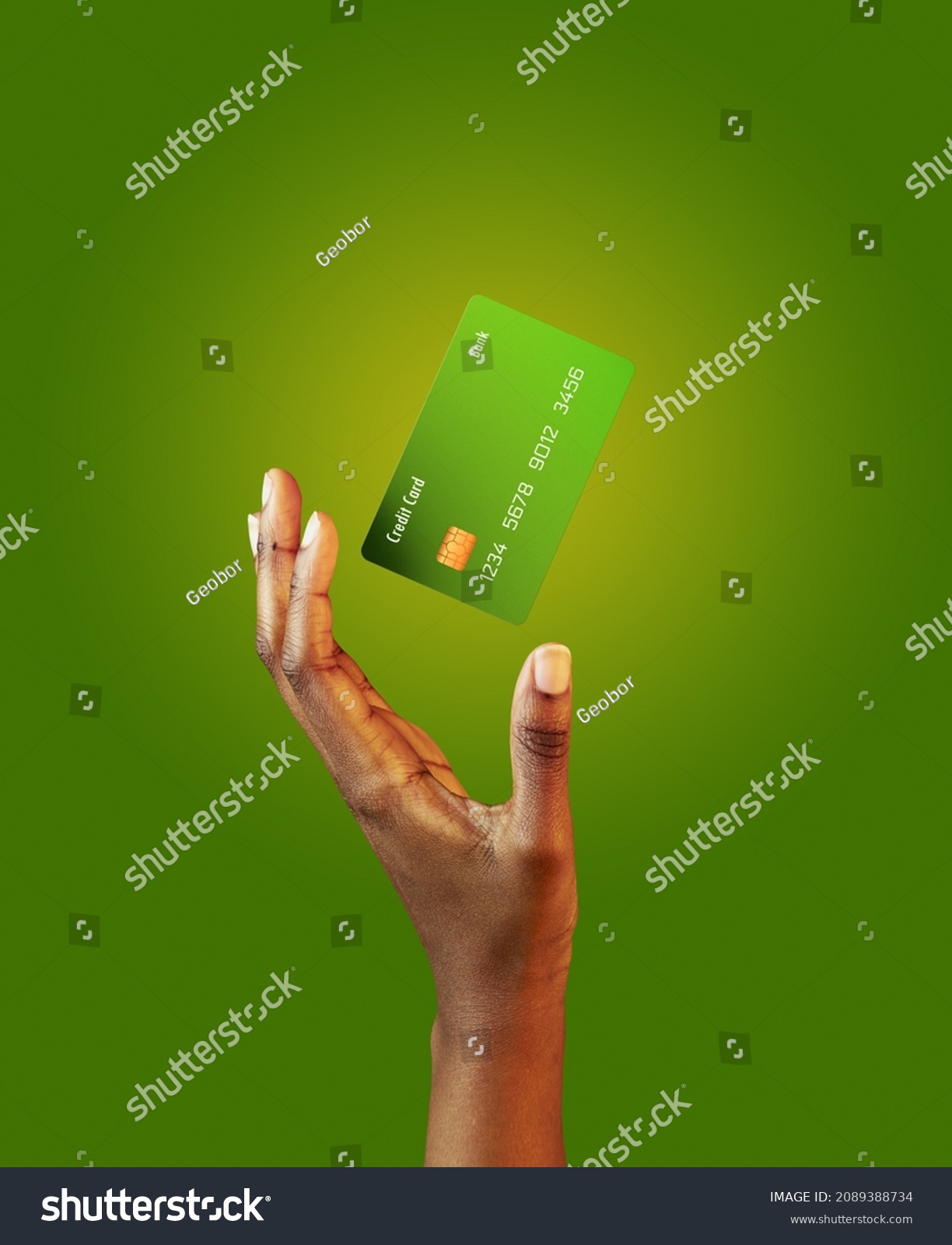 African american female hand and levitating template mockup Bank credit card with online service on green background #2089388734