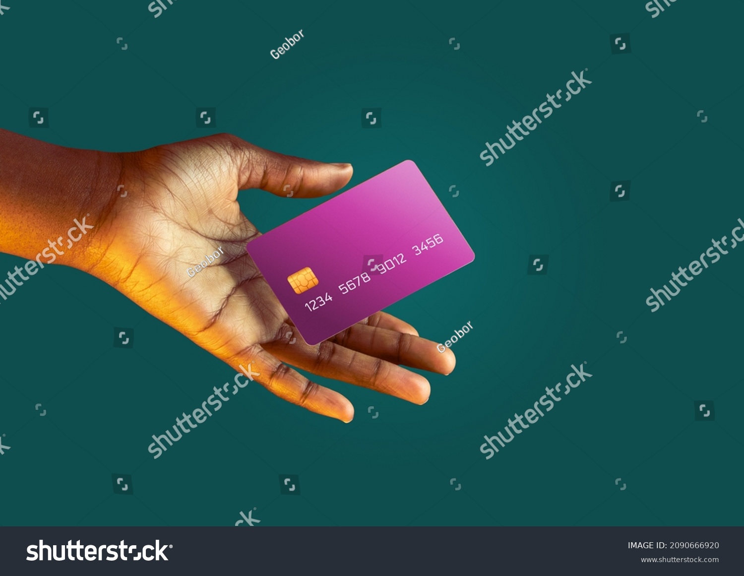 African american female hand holds levitating template mockup Bank credit card with online service on green background #2090666920