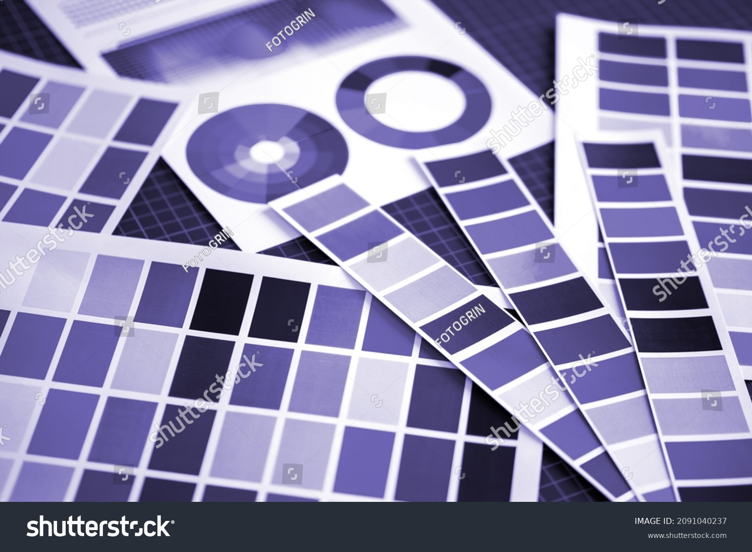 Purple palettes on table. Popular lilac color. Mixture of blue and lilac with different shades. Trendy popular colors. Design paper polishes. Designer workplace close-up.  #2091040237