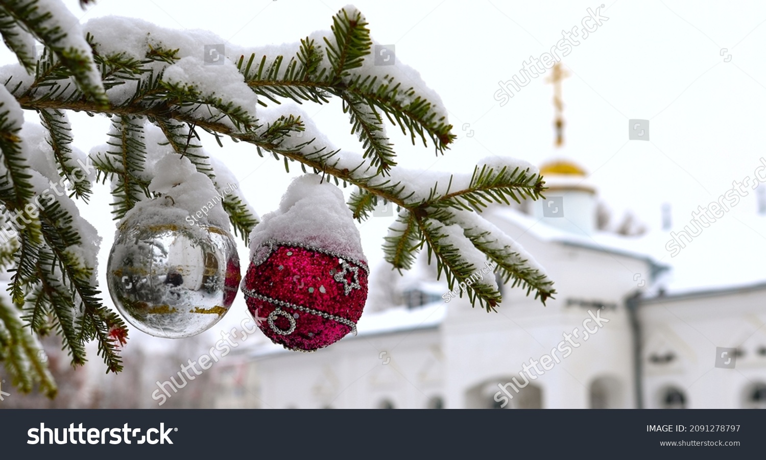 Christmas tree branch with decorations on the background of the Orthodox cross with a crucifix. The Orthodox Church. Winter is Christmas. The concept of Orthodoxy. #2091278797
