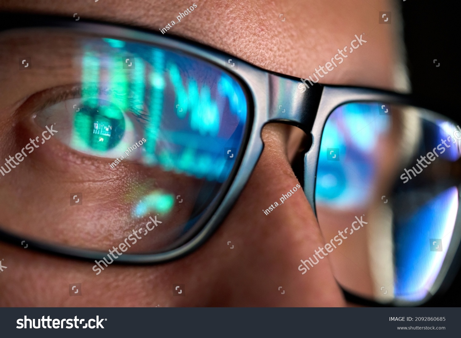 Focused crypto trader analyst wearing eyeglasses working looking at computer screen reflecting in glasses analyzing online trading stock exchange market data charts. Close up eye reflection. #2092860685