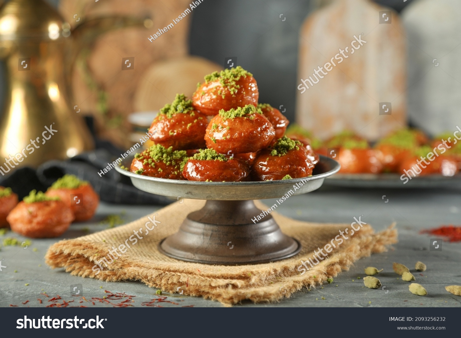 Arabic dessert Middle Eastern traditional dessert Ramadan dessert "Zalabya",or Luqmat Al-Kadi, Sub Alqafsha served with honey, pistachio cinnamon, sugar and oriental tea. Close up with copy space. #2093256232