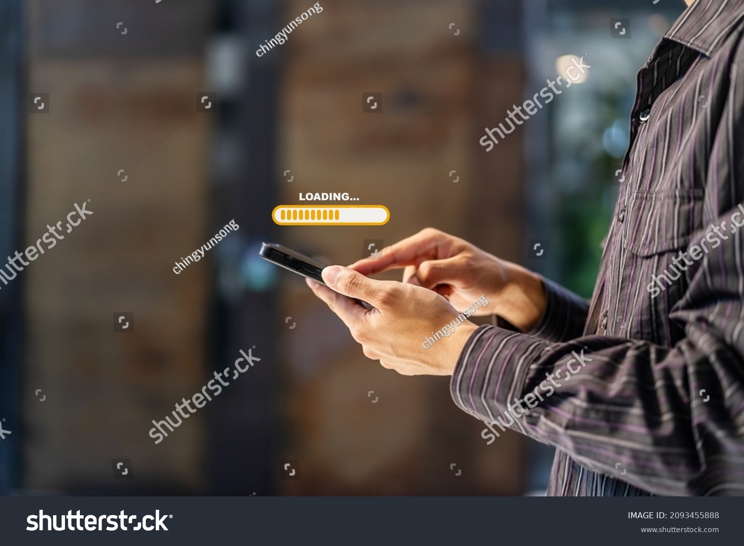 Hand man using mobile smartphone for download application and waiting to loading. Loading icon on screen. businessman downloading digital business data form website and cloud to smartphone #2093455888
