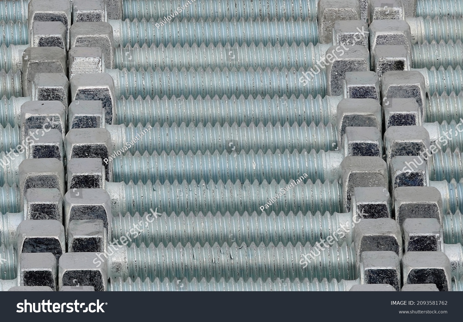 A background of rows of high strength chrome plated bolts with a turquoise sheen, close-up. #2093581762