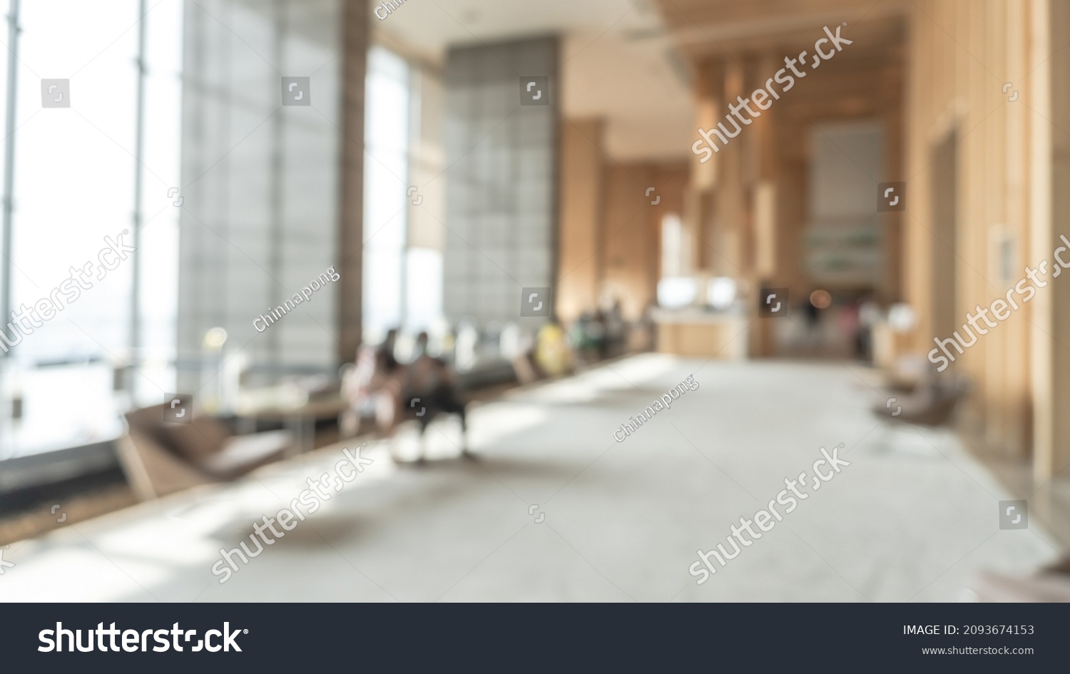 Blurred hotel or office building lobby blur background interior view toward reception hall, modern luxury white room space with blurry corridor and building glass wall window #2093674153