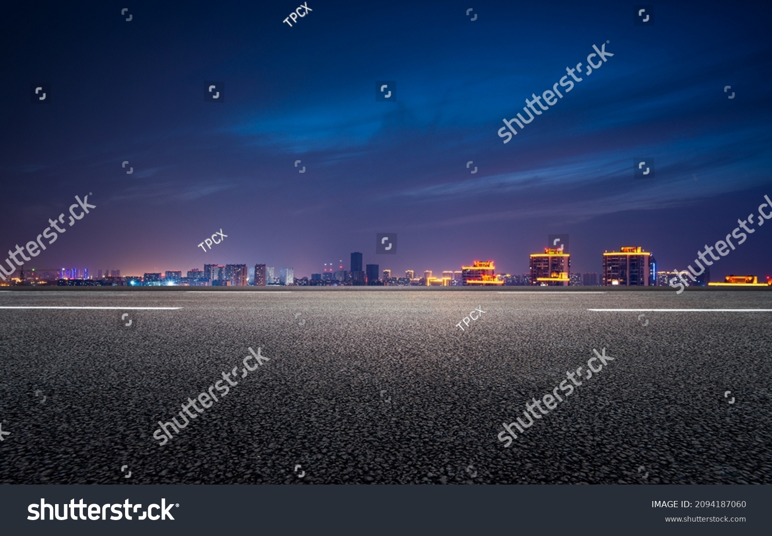 The night view of the city in front of the asphalt road #2094187060