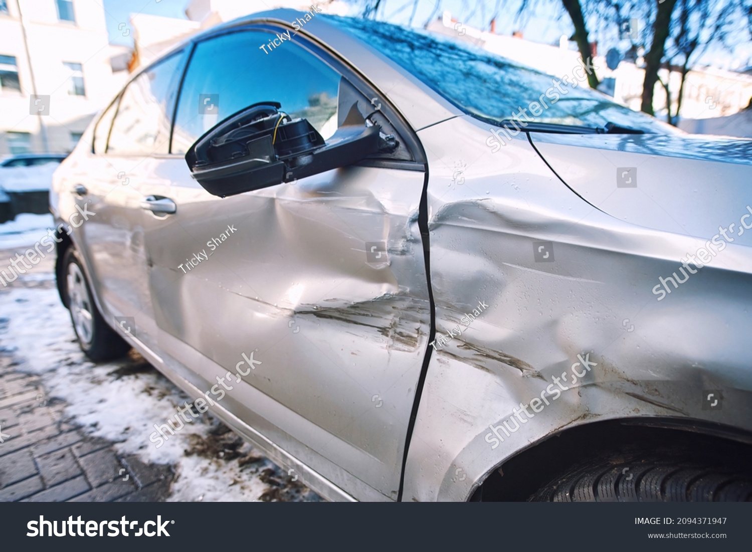 Car body side damage, traffic accident in winter season. Car door damage, broken and damaged side mirror on car door. #2094371947