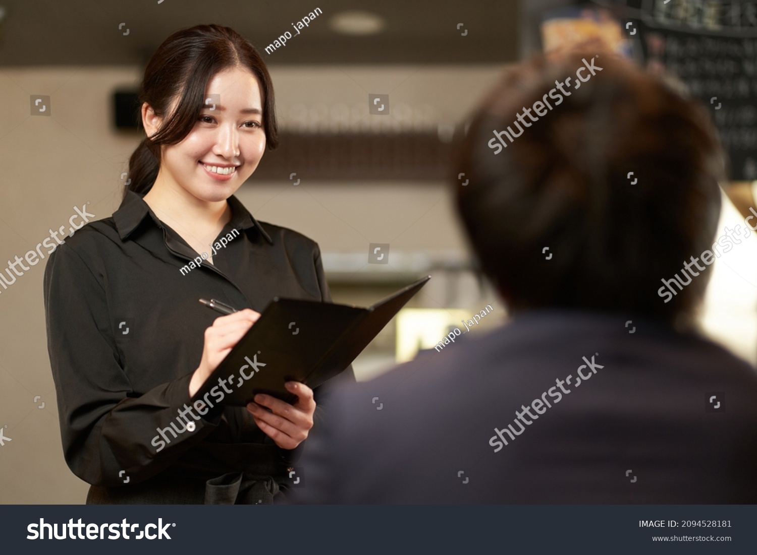Asian female taking an order at a restaurant #2094528181
