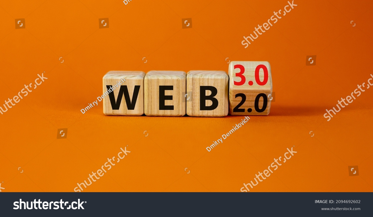 WEB 2 or 3 symbol. Turned a wooden cube and changed words WEB 2.0 to WEB 3.0. Beautiful orange table, orange background, copy space. Business, technology and WEB 2.0 or 3.0 concept. #2094692602