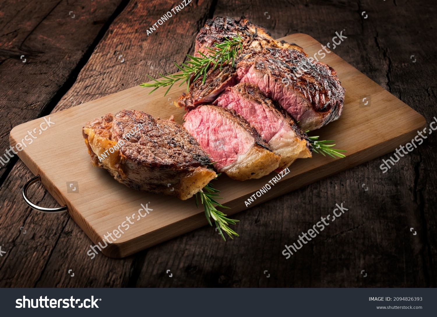 Fiorentina T-bone steak cut on rectangular wooden chopping board and vegetables isolated on white background #2094826393
