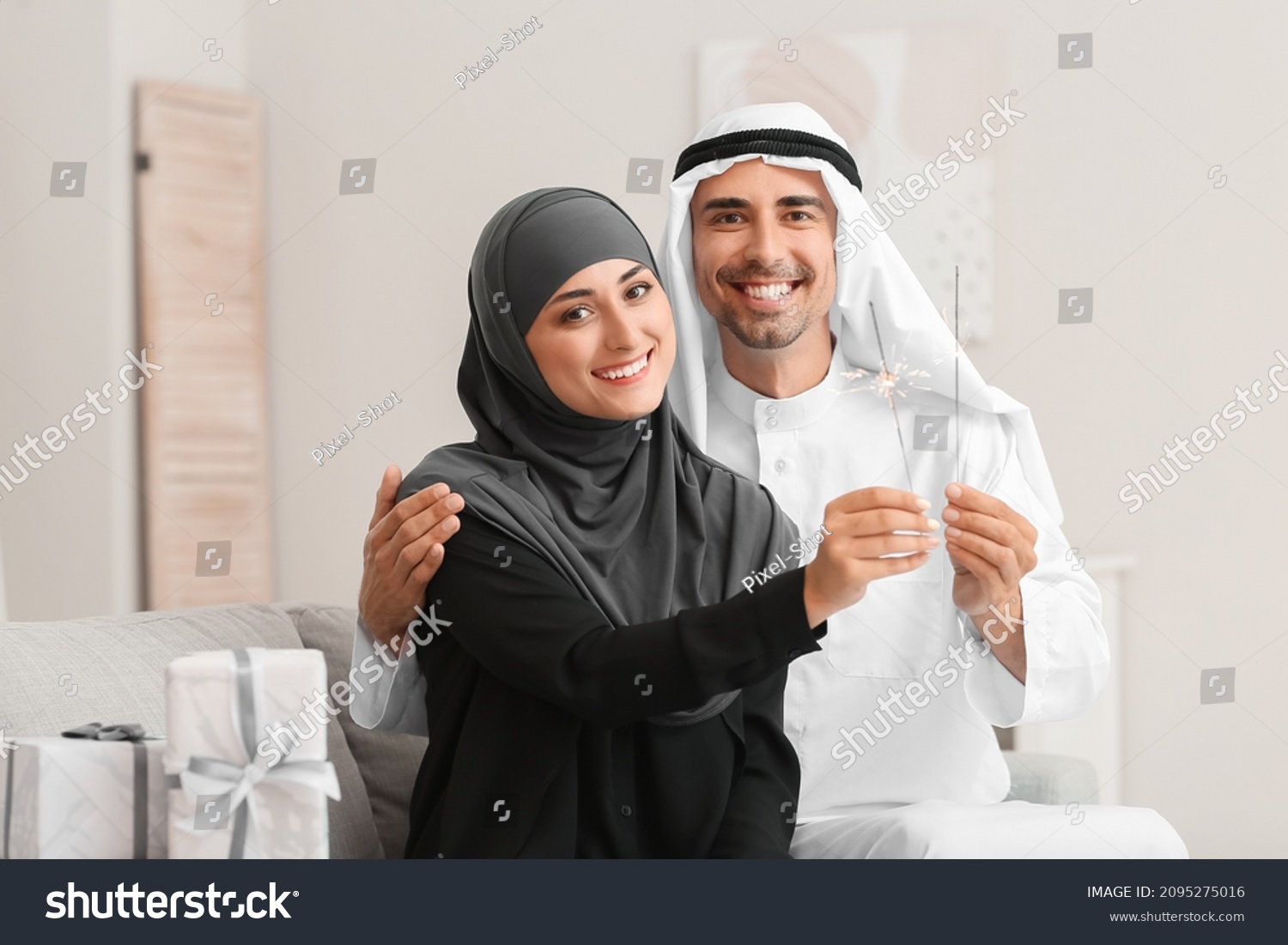 Young Muslim couple with sparklers at home #2095275016