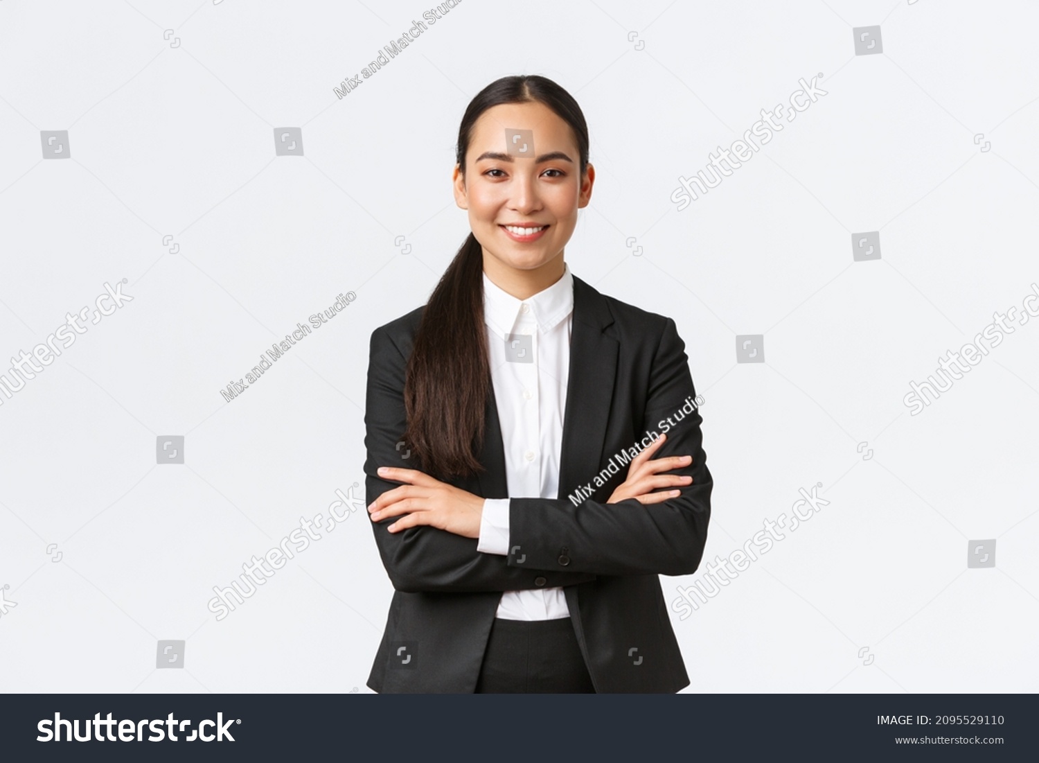 Successful young asian businesswoman in suit ready do business, cross arms confident and smiling. Female entrepreneur determined to win. Happy saleswoman talking to clients, white background #2095529110