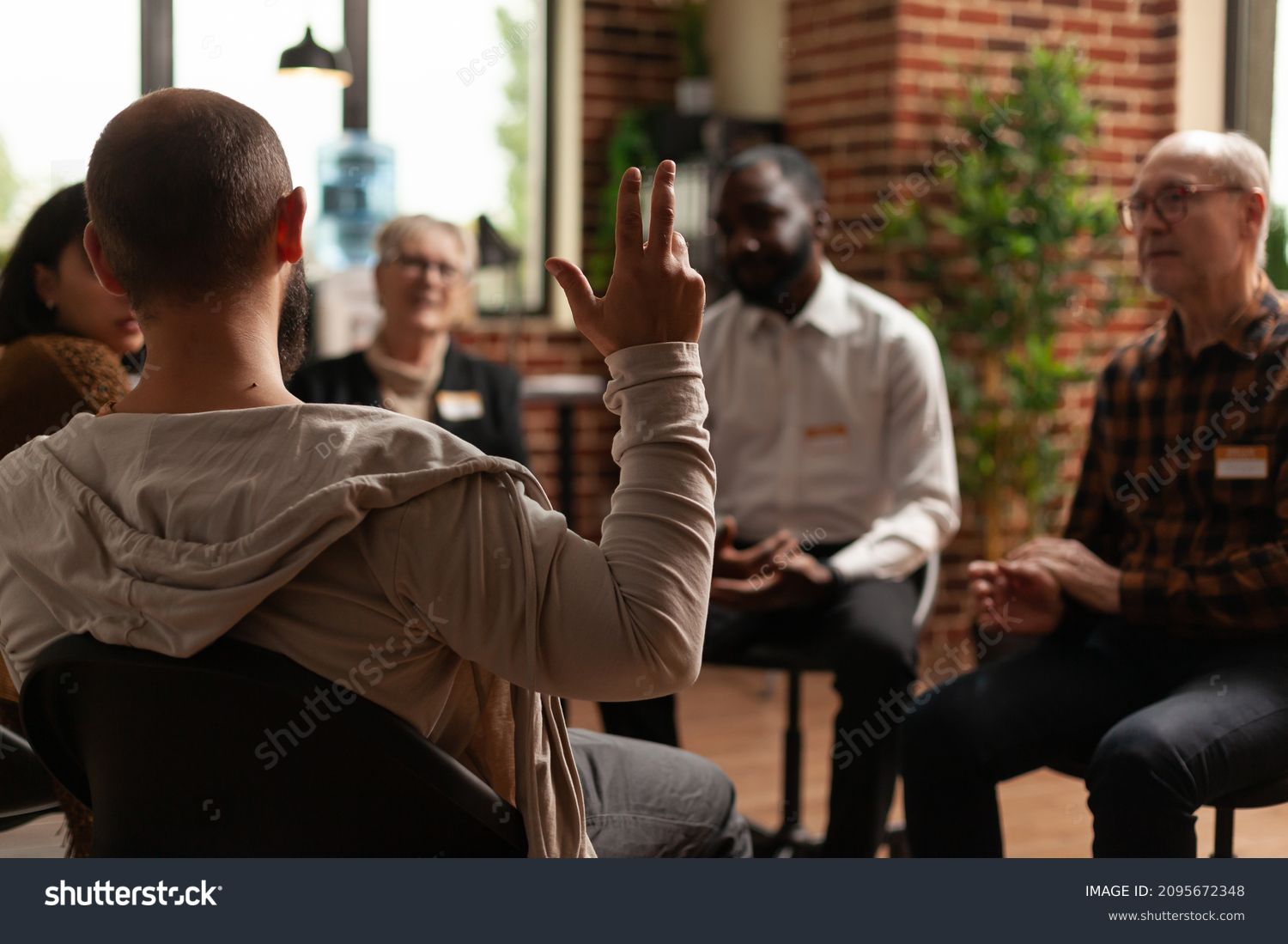 Man with addiction sharing health problems with group at aa meeting, talking to therapist. Alcoholic people having conversation about depression and rehabilitation at therapy session. #2095672348