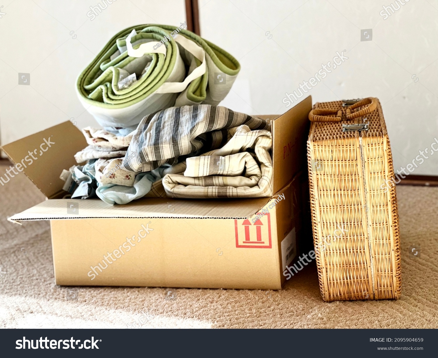 Clothes and baskets in cardboard boxes #2095904659