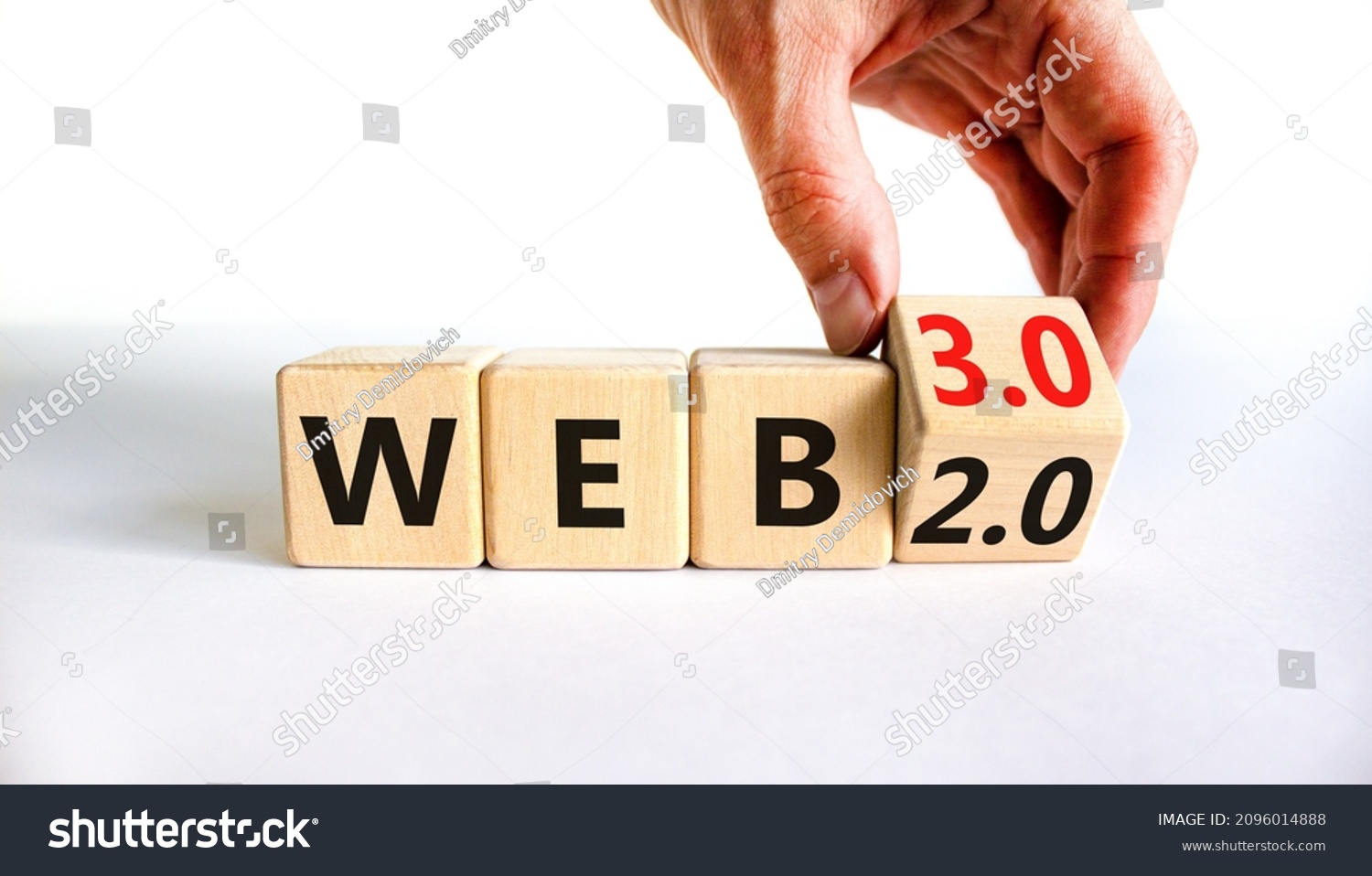 WEB 2 or 3 symbol. Businessman turns a wooden cube and changes words WEB 2.0 to WEB 3.0. Beautiful white table, white background, copy space. Business, technology and WEB 2.0 or 3.0 concept. #2096014888