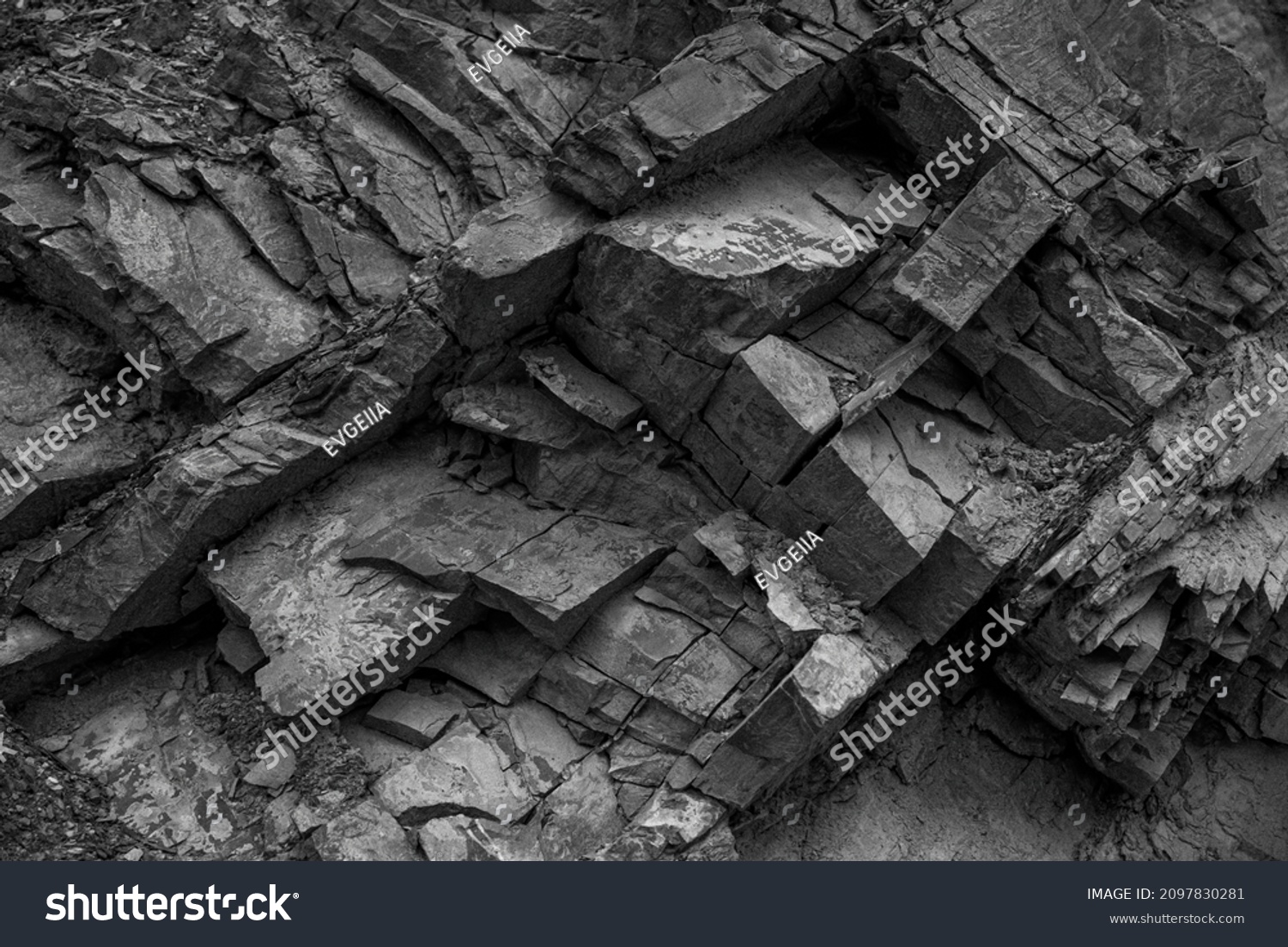 Texture, background layers and cracks in sedimentary rock on cliff face. Cliff of rock mountain. Rock slate in the mountain. Seamless abstract background. Cracks and layers of sandstone.
 #2097830281