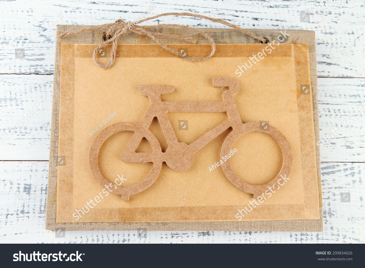 Decorative bicycle on book on wooden background #209834026