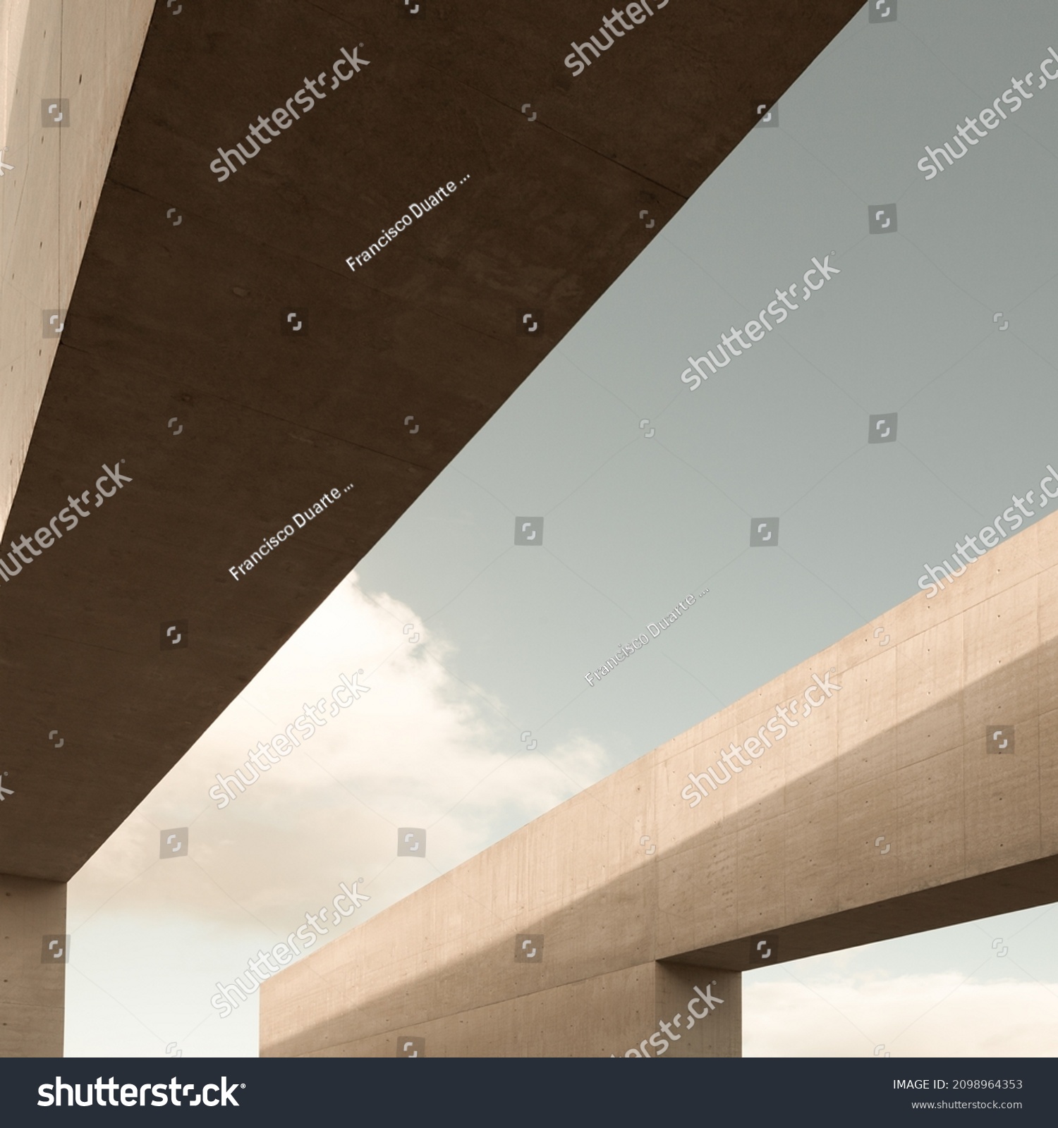 Exterior detail geometric structure fragments building. Abstract shape, minimal architectural background. Modern construction made of two large reinforced concrete blocks. Light tones. security safety #2098964353