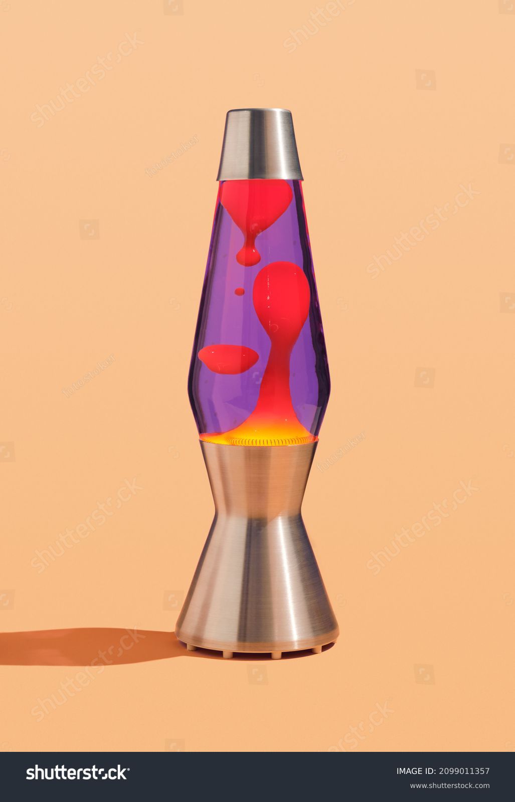 Table colorful lava lamp with flowing traceries. Peace and comfort in interior. Retro style. #2099011357