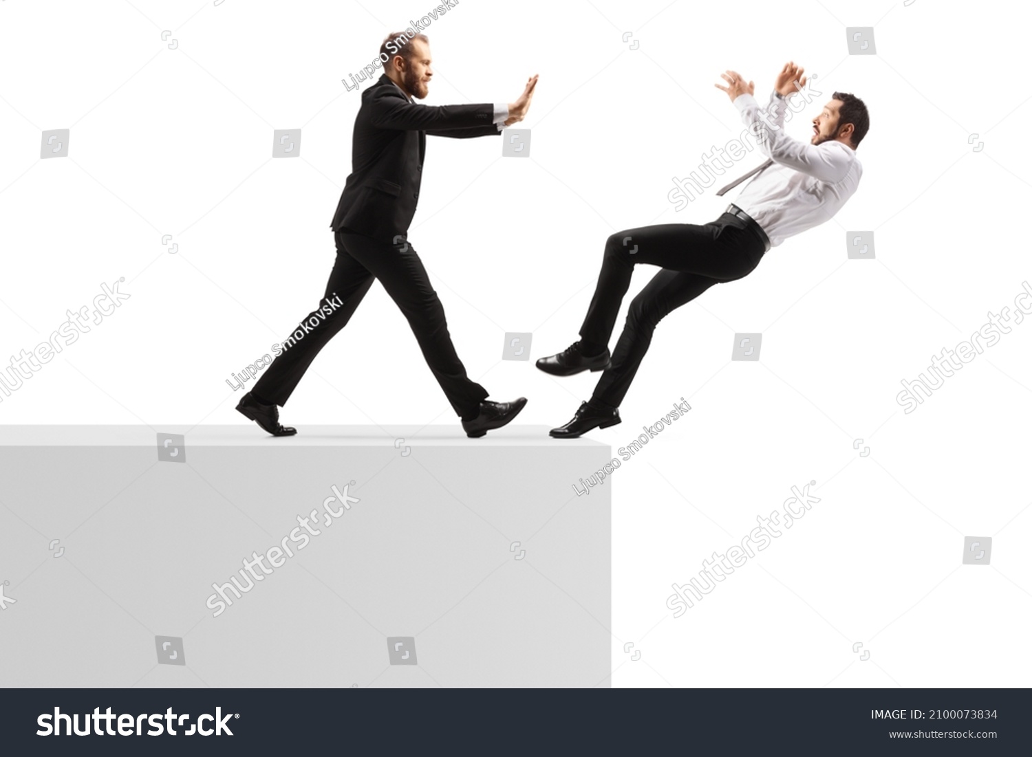 Full length profile shot of a businessman pushing a man from a wall isolated on white background #2100073834