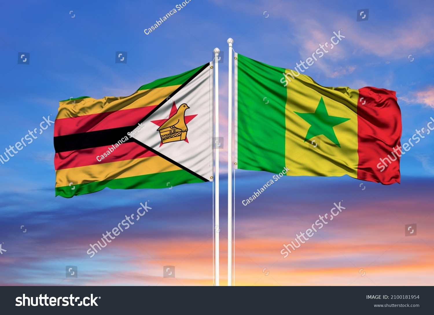 Senegal and Zimbabwe two flags on flagpoles and blue cloudy sky  #2100181954