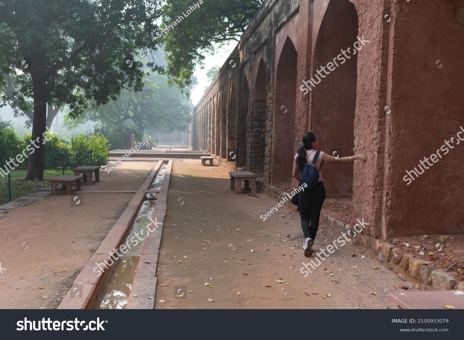 Traveler or tourist exploring historical structure of Humayun's tomb which is a UNESCO world heritage site situated in Delhi. History, geography, site seeing, architecture, archaeology, travel, study #2100933079