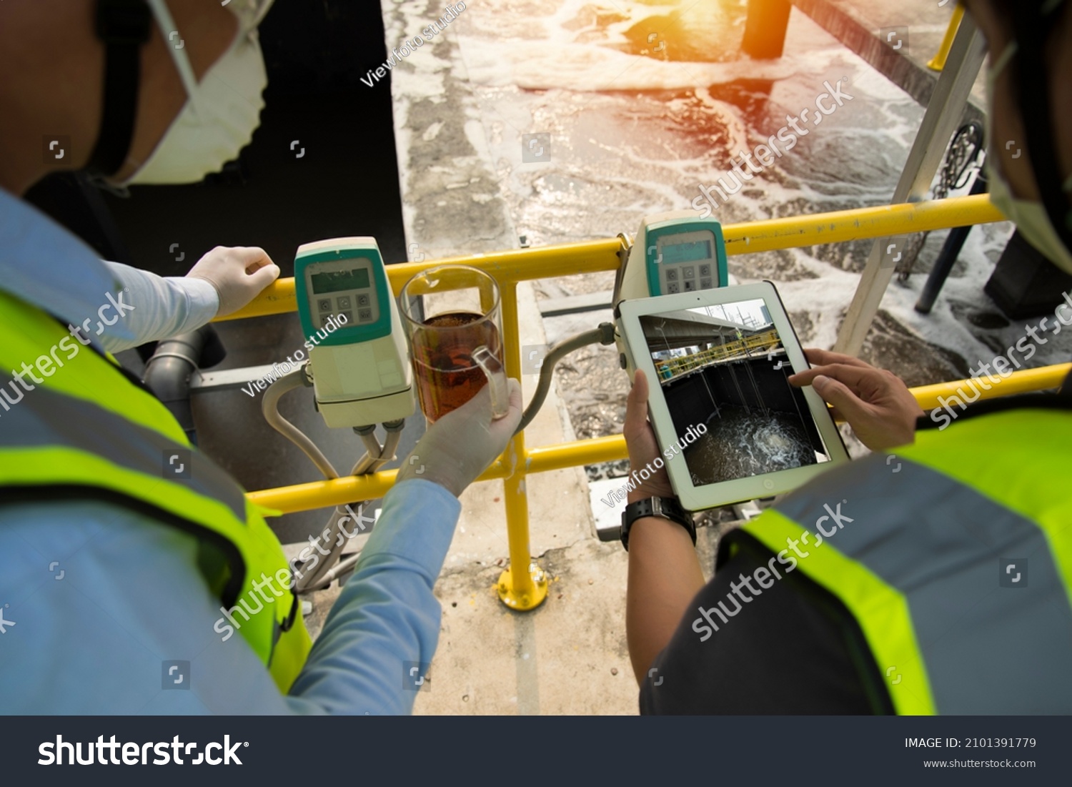 Wastewater treatment concept. Service engineer on  waste water Treatment plant and checking oxygen in water with tablet.  Wastewater treatment concept. Service engineer on waste water Treatment plant. #2101391779