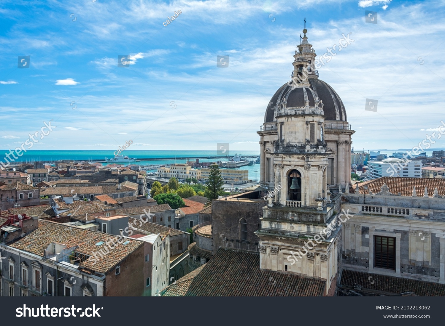 View over the cityscape of Catania on the island of Sicily in Italy with famous cathedral (Cattedrale di Sant'Agata) and harbour  #2102213062