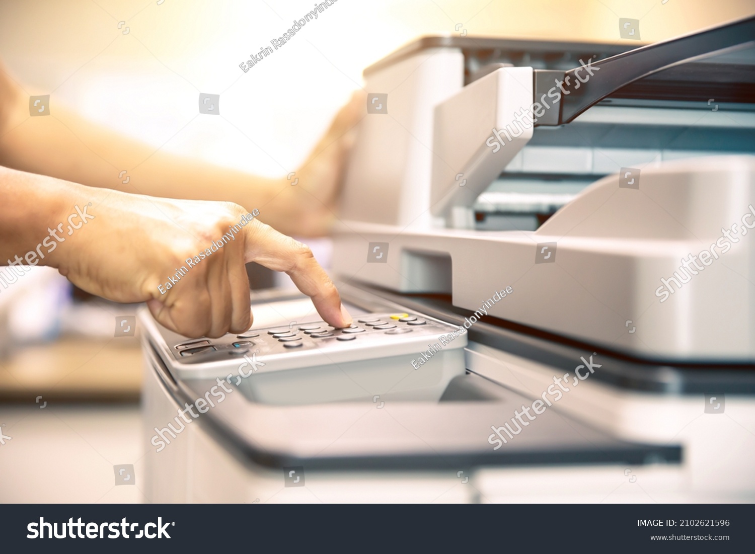 Copier printer, Close up hand office man press copy button on panel to using the copier or photocopier machine for scanning document printing a sheet paper and xerox photocopy. #2102621596