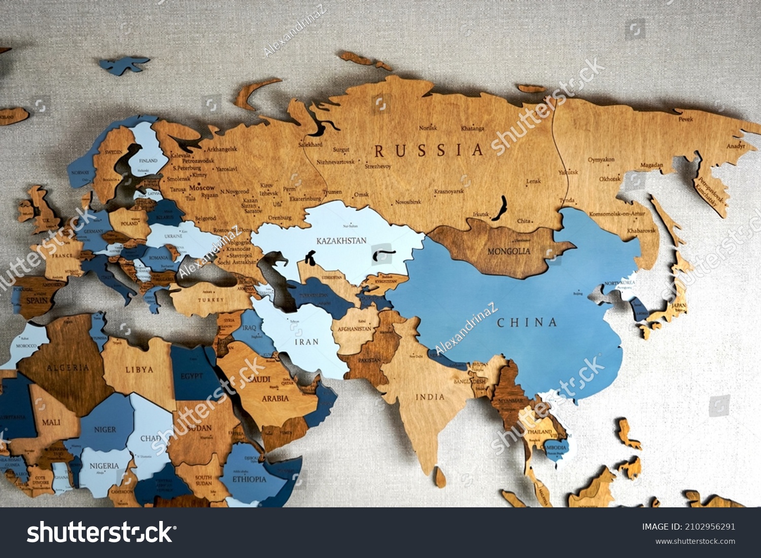Continent Eurasia on the political map. Wooden world map on the wall.  #2102956291