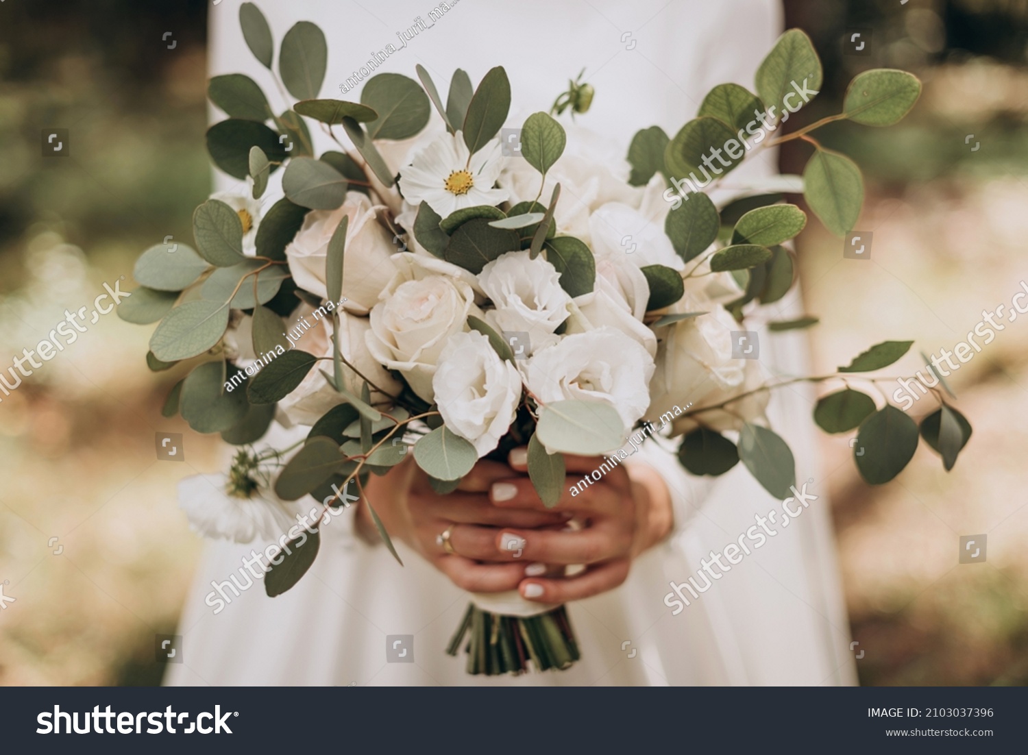 Very beautiful wedding bridal bouquet, made of white roch and austoma, and yellow daisies, green casting of eucalyptus.  Wedding, engagement. Bride and groom. Bride's wedding bouquet. #2103037396
