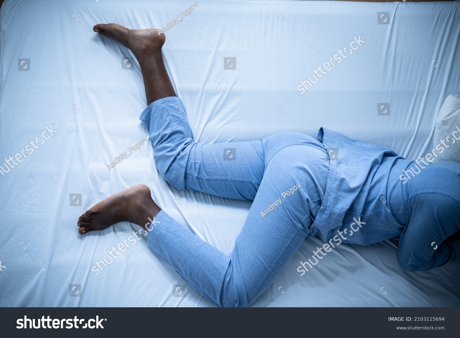 African American Man With RLS - Restless Legs Syndrome. Sleeping In Bed #2103115694