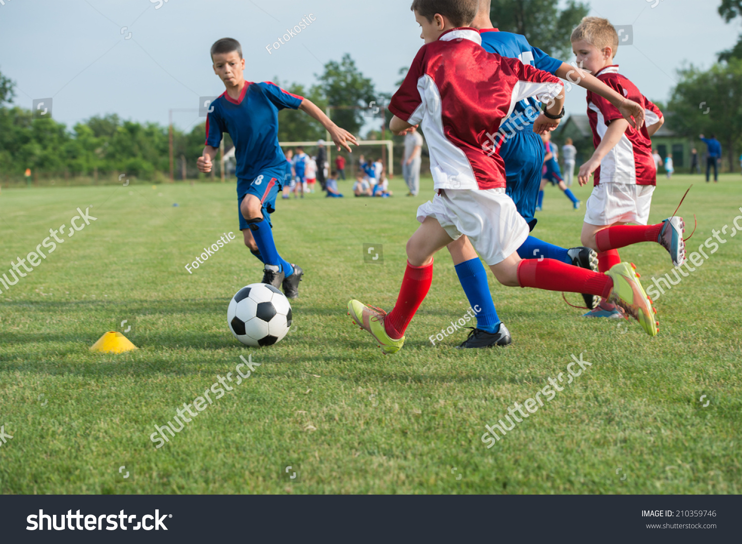 boys kicking football on the sports field #210359746