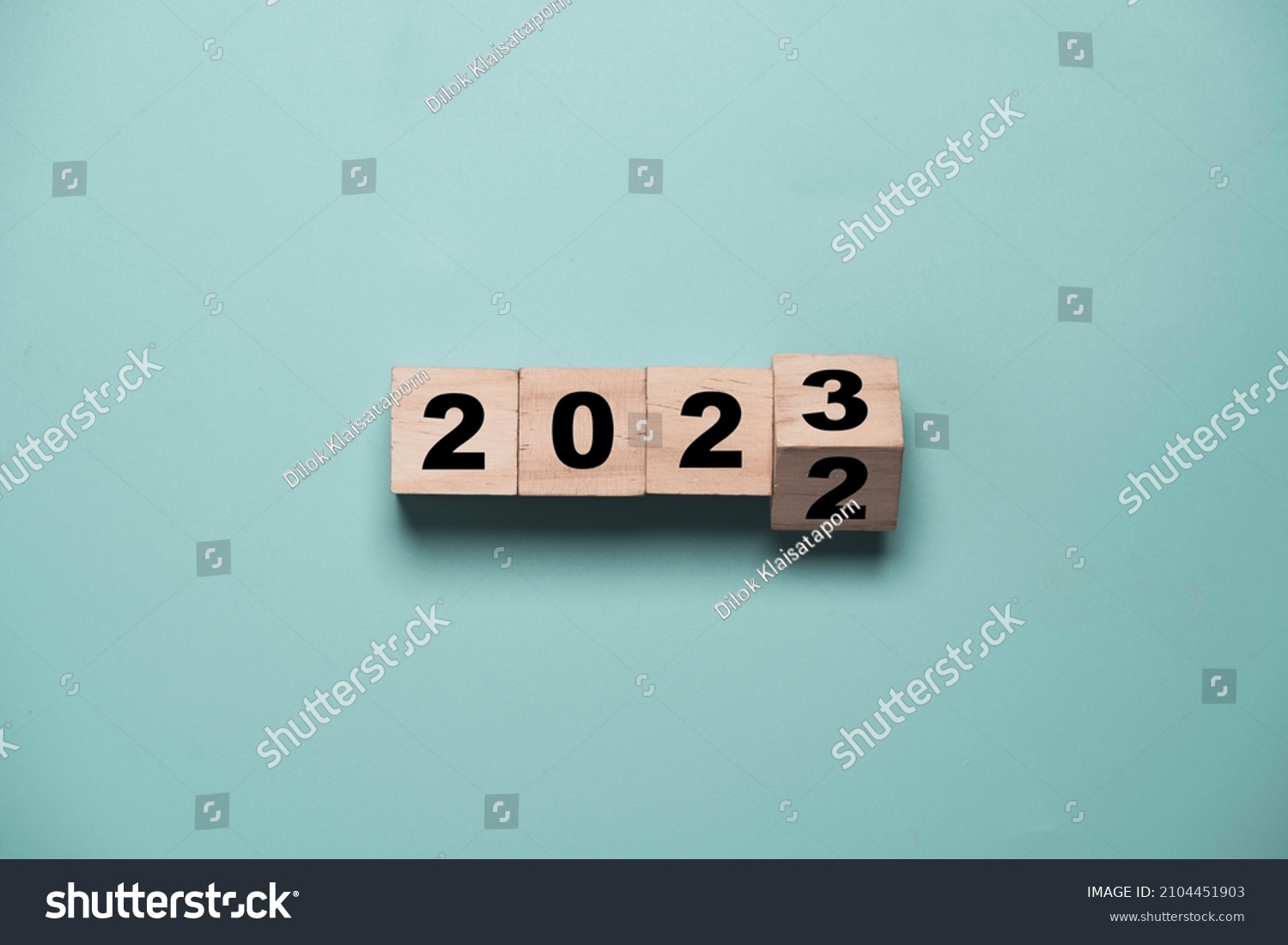 Flipping of 2022 to 2023 on wooden block cube for preparation new year change and start new business target strategy concept. #2104451903