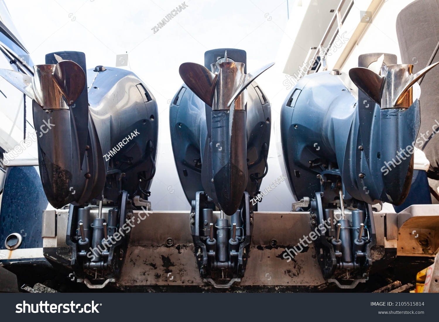 Three outboard motors mounted on the stern of a motor boat, bottom view. #2105515814