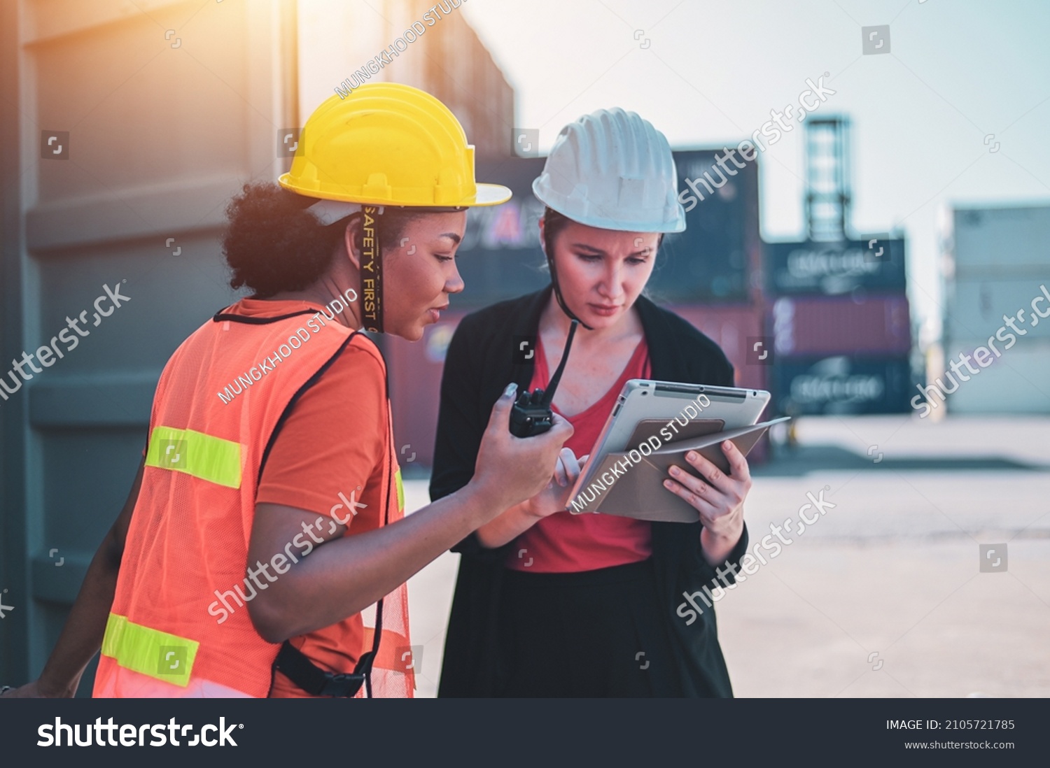 Team worker American women Work in an international shipping yard area Export and import delivery service with containers #2105721785