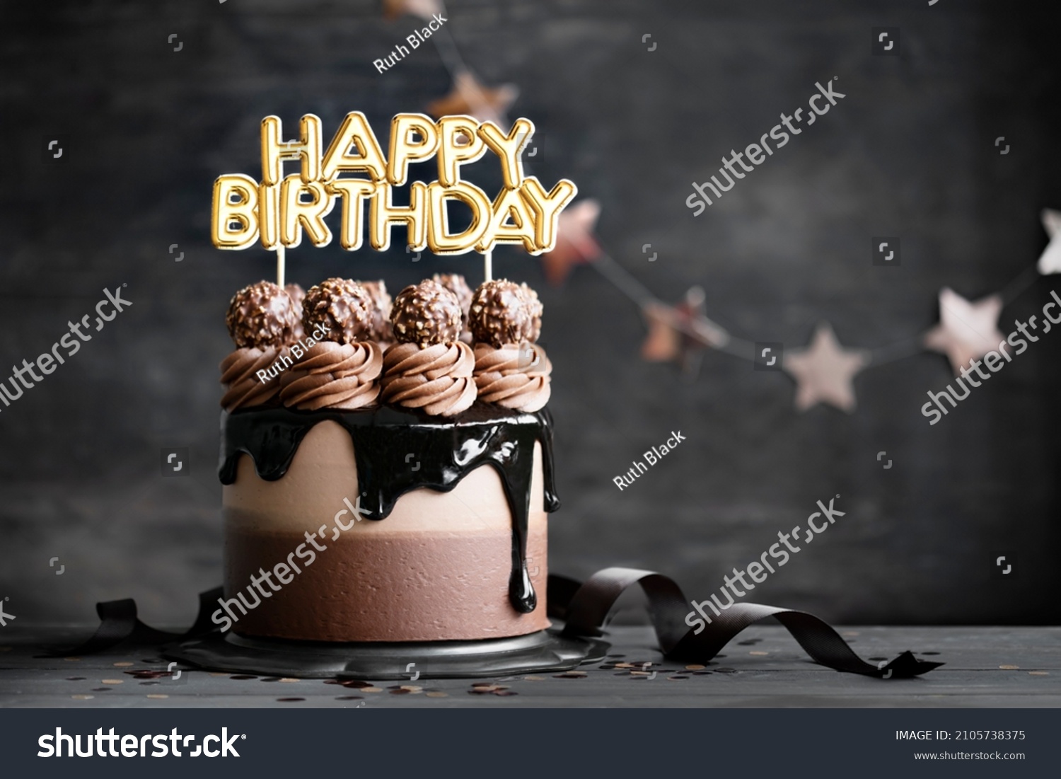 Chocolate birthday cake with  chocolate ganache drip icing and happy birthday banner #2105738375